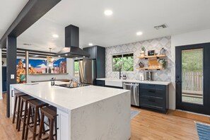 Enjoy cooking in this well-lit kitchen with a large island and stainless steel appliances.