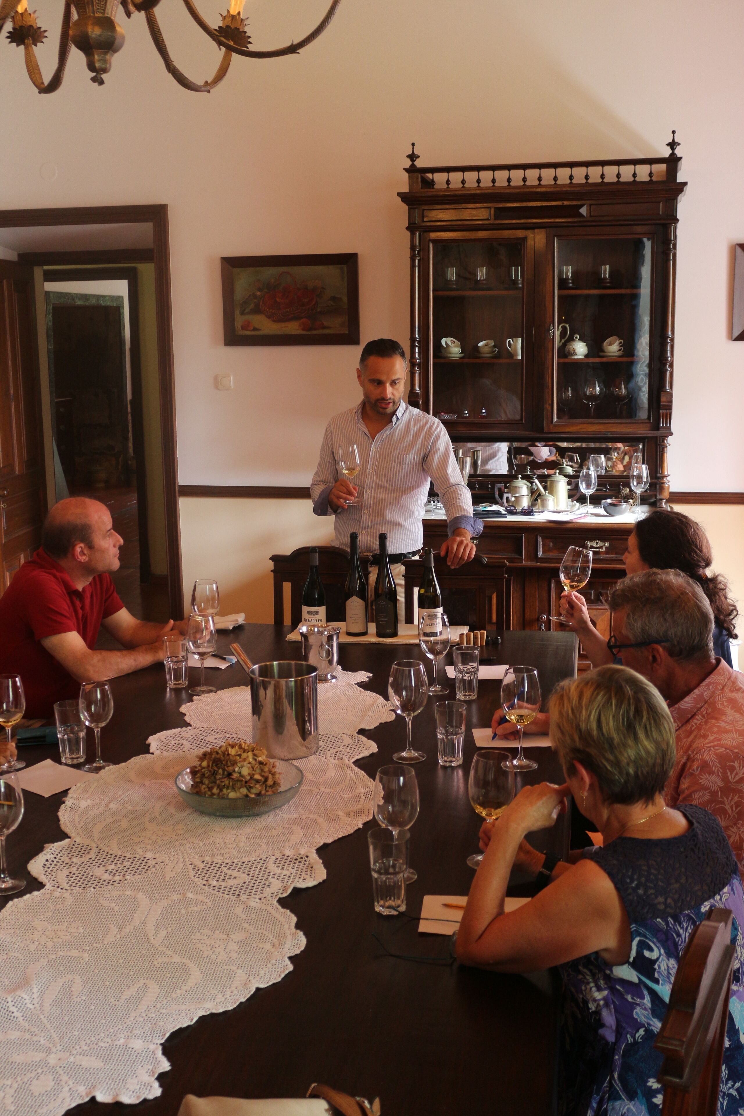 A dining room with a table set for a meal, surrounded by guests.