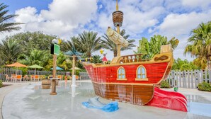 Ein Wasserpark im Piratenschiff-Design mit Wasserrutschen und Steuerrad.