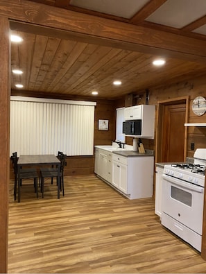 Enjoy cooking in this well-equipped kitchen with a central island, gas stove, and microwave.