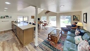 A spacious living area with a large island, a dining table, and a sofa. - Mountain Hideaway - Hot Tub, 3 Living Areas, 5 min. to Shop/Ski (Park City)