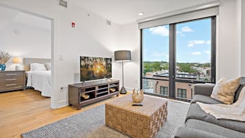 Habitación individual Premium, 1 cama Queen size, se aceptan mascotas, vista a la ciudad | Área de sala de estar | Televisión de 65 pulgadas con canales digitales, Netflix y Hulu
