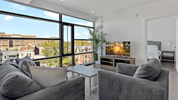 Deluxe Apartment, 2 Bedrooms, City View | Living area | 65-inch TV with digital channels, Netflix, Hulu