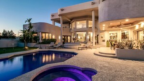 A modern house with a swimming pool, outdoor seating, and a well-lit patio area. - Stunning Private & Modern N. Scottsdale Estate! (Scottsdale)