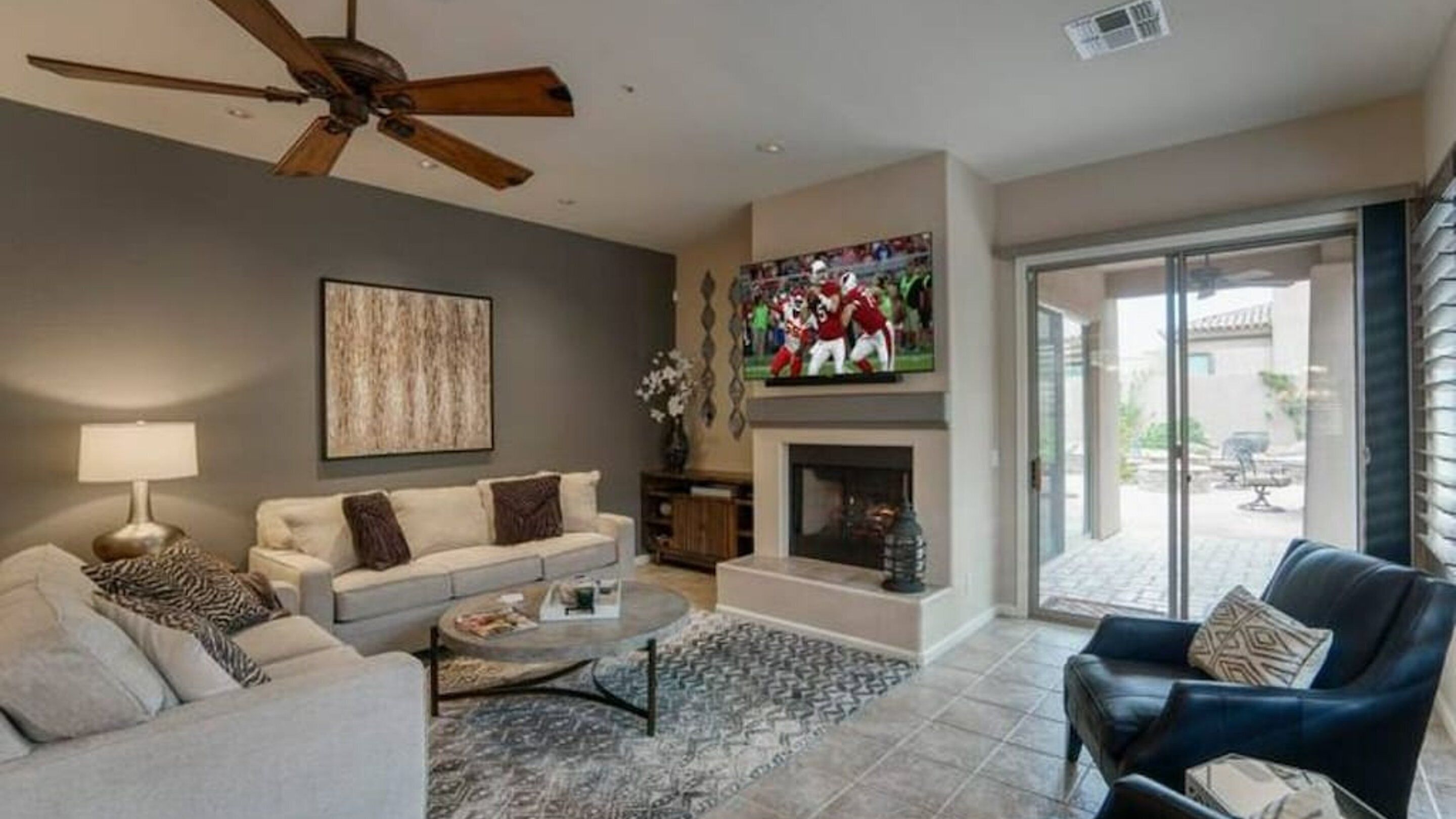 A living room with a sofa, coffee table, and a fireplace.