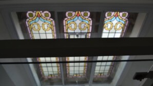 A view of a room with a skylight and three stained glass windows. - Church Conversion 3-bed House in Centre of Kendal (Kendal)