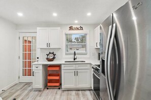 Enjoy cooking in this well-equipped kitchen with an oven, refrigerator, and sink.