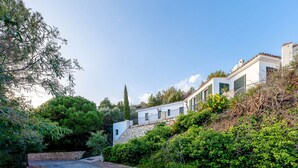 A residential property with a stone wall, a paved driveway, and lush greenery. - Spectacular Views Private Villa Valtocado (Mijas Pueblo)