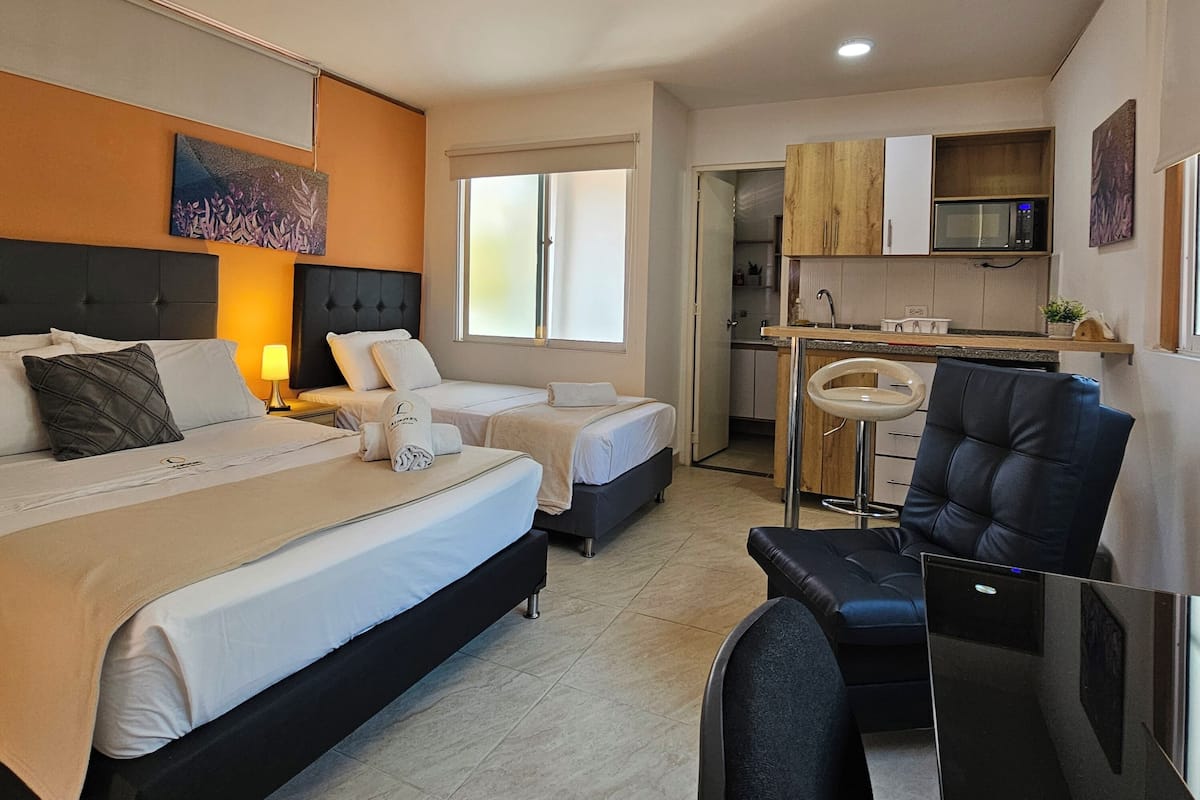 Superior Studio, Multiple Beds | Living area | 32-inch TV with cable channels, books