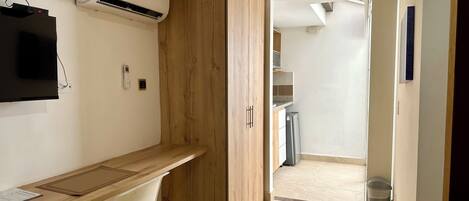 A modern kitchen with a built-in oven, a refrigerator, and a countertop.