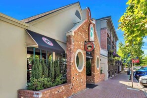 A building with a brick facade, circular windows, and a sign that reads 'SCHUTZ BREWERY.'