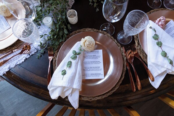 A table set with plates, cutlery, and a menu. - Rustic Cabin with glamour. Private, mature trees & close to provincial park (Ardrossan)