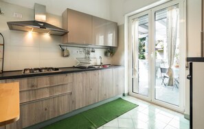 Fridge, stovetop, dishwasher, coffee/tea maker