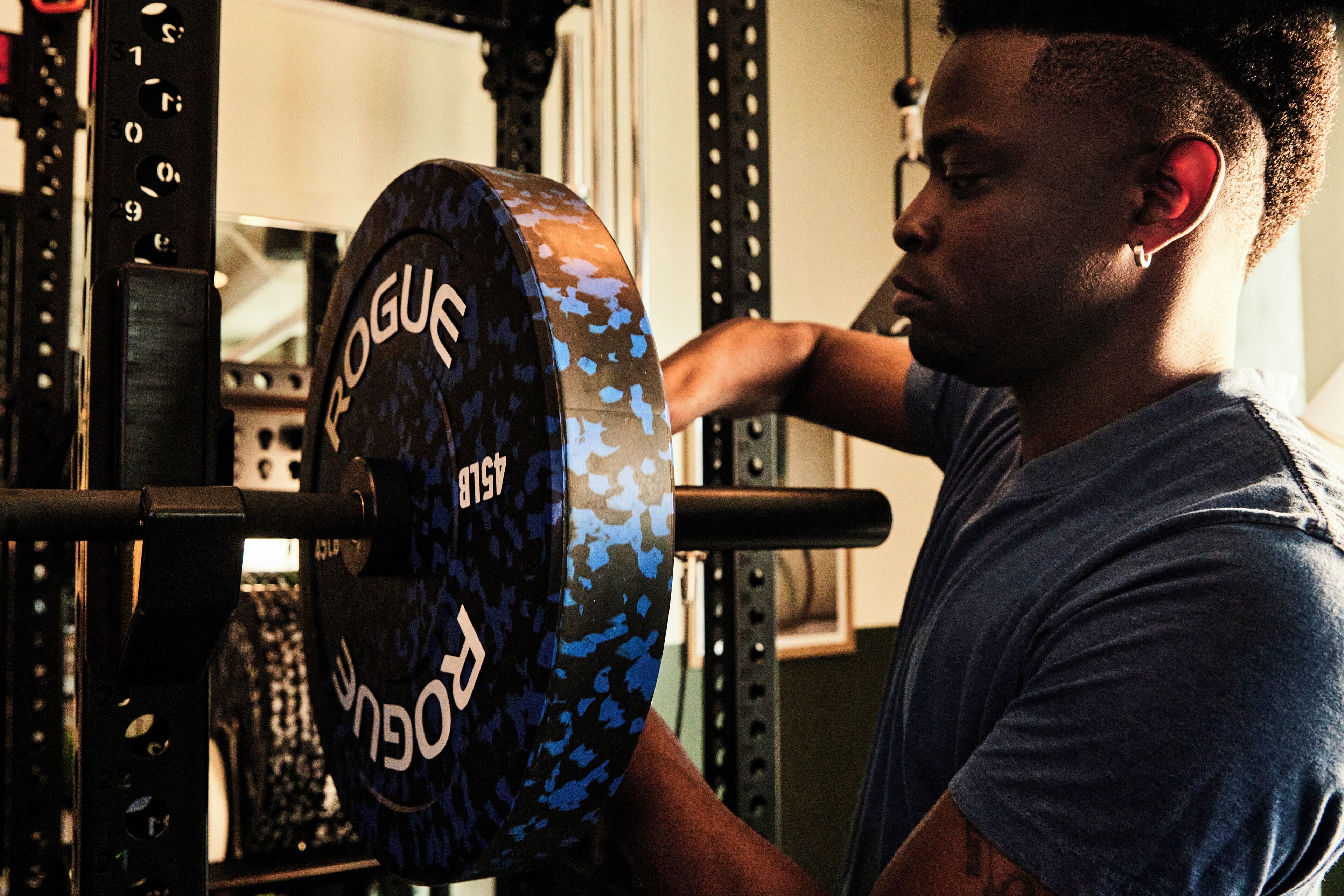 A person using a weightlifting machine with a blue camouflage pattern.