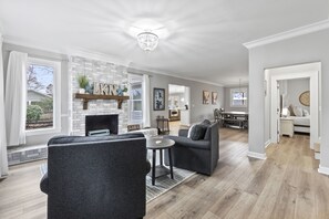 Cozy living area with a fireplace, comfortable seating, and a view of the outdoors.