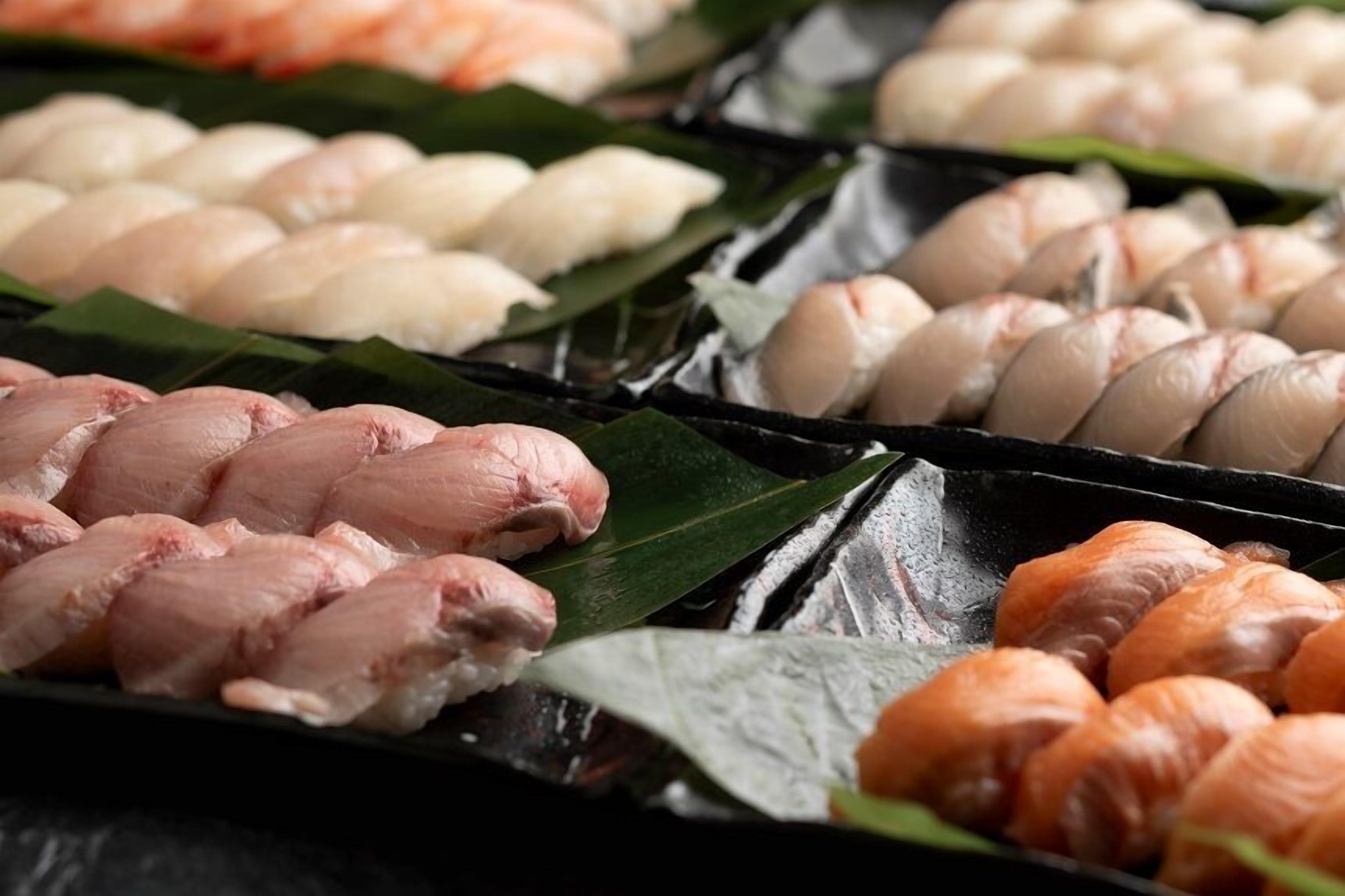 A variety of sushi arranged on a tray.