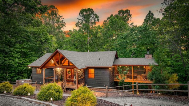A log cabin with a porch, a chimney, and a deck. - Knotty Dreams - Luxury Awaits, Hot Tub, Party Porch (Mineral Bluff)