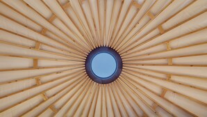 A circular skylight with wooden beams radiating outward.