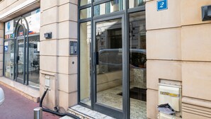 A building entrance with a glass door, a blue sign with the number 2, and a mailbox on the right. - 2-Br. steps from the Palais des Festivals (Cannes)