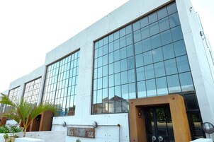 A modern building with large glass windows and a white facade.