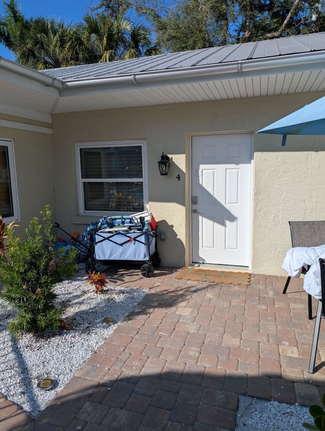 A house with a covered patio, a door, and a window.