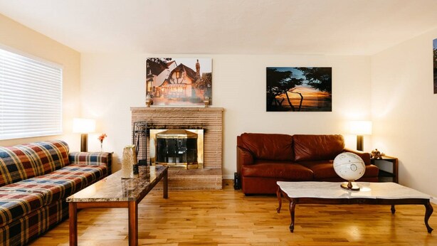 A living room with a fireplace, a sofa, a coffee table, and a couch. - glorious sunsets  (Seaside)