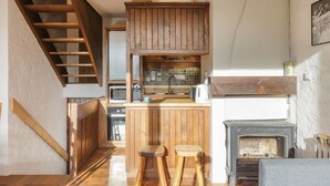 A kitchen with wooden cabinets, a built-in stove, and a wooden staircase. - La Maison De Montroc Family-Holidays w/4BR, + Fireplace, Sleeps 8, Le Tour (Argentière), France (Le Tour (Argentière))