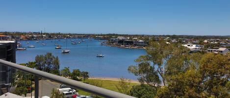 A marina with boats, a parking lot, and buildings in the background.
