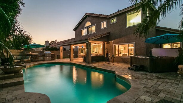 A two-story house with a swimming pool, outdoor patio, and a hot tub. - Luxe Scottsdale Home W/pool, Spa, & Tesla Charger (Scottsdale)