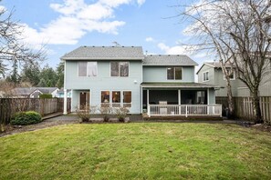 A two-story house with a front porch and a small front yard.