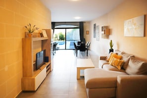 Relax in this inviting living space with a comfortable sofa, flat-screen TV, and a view of the outdoors.
