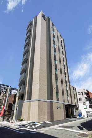 A tall, modern hotel with a prominent entrance and multiple floors. - Hotel Reference Hakata Reisen (Fukuoka)
