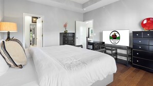 A bedroom with a bed, a desk, a dresser, and a ceiling fan. - 3BR/3BA Golf Course Condo • Upgraded Kitchen • Discount Tickets & Golf! (Branson)