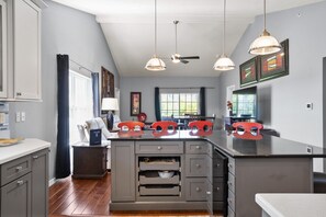 Enjoy cooking in this well-equipped kitchen with a central island, oven, and microwave.