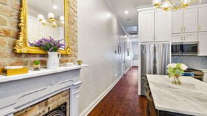 A modern kitchen with white cabinets, a stainless steel refrigerator, and a marble countertop. - Insta Ready Meets Modern Comfort - Stylish 2BD/2BA (New Orleans)