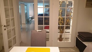 A room with a white door, a yellow table, and a chair. - Apartment Vinko, Center (Zagreb)