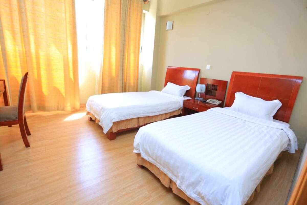 twin room | in-room safe, desk, laptop workspace, iron/ironing board