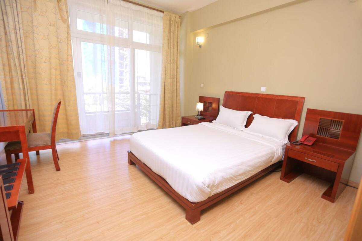 deluxe single room | in-room safe, desk, laptop workspace, iron/ironing board