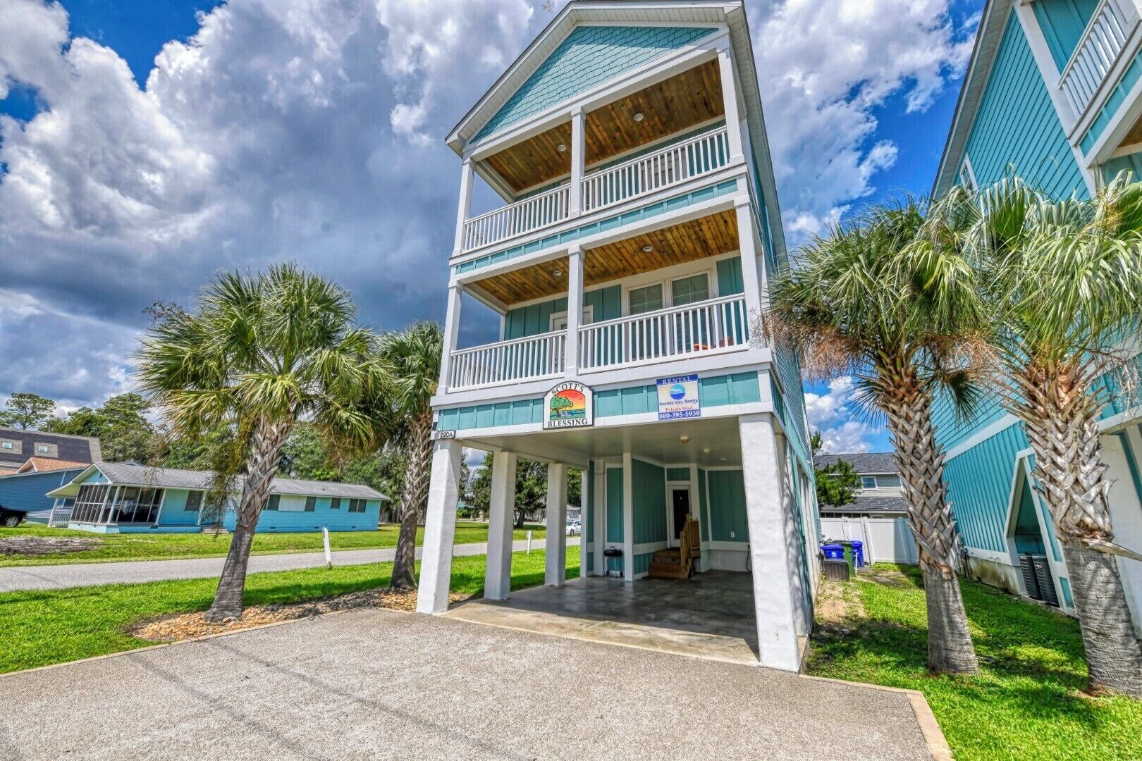 A two-story building with a balcony, a sign indicating it's for rental, and a small porch area.