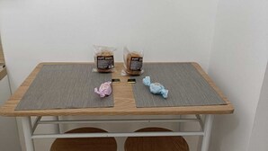 A small table with two chairs, a bag of bread, and a pink and blue toy on the table. - Mirosa mini loft for you. (Bari)