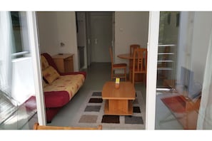 A compact living space with a sofa, a small table, and a chair.