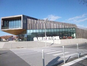 A modern building with a large glass facade and a prominent 'UNIVERSITY' sign.