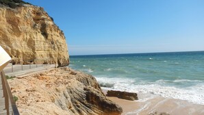A coastal cliff with a walkway leading to the beach. - Carvoeiro Sol Right by the sea (Carvoeiro)