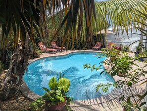 A swimming pool with lounge chairs and potted plants around it. - The Ave House- A Private Oasis Retreat with Pool (Fort Lauderdale)