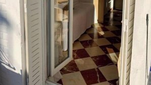 A narrow hallway with a checkered floor leading to a room with a white door. - Home Sweet Home Claridge Champs-Elys ées (Paris)