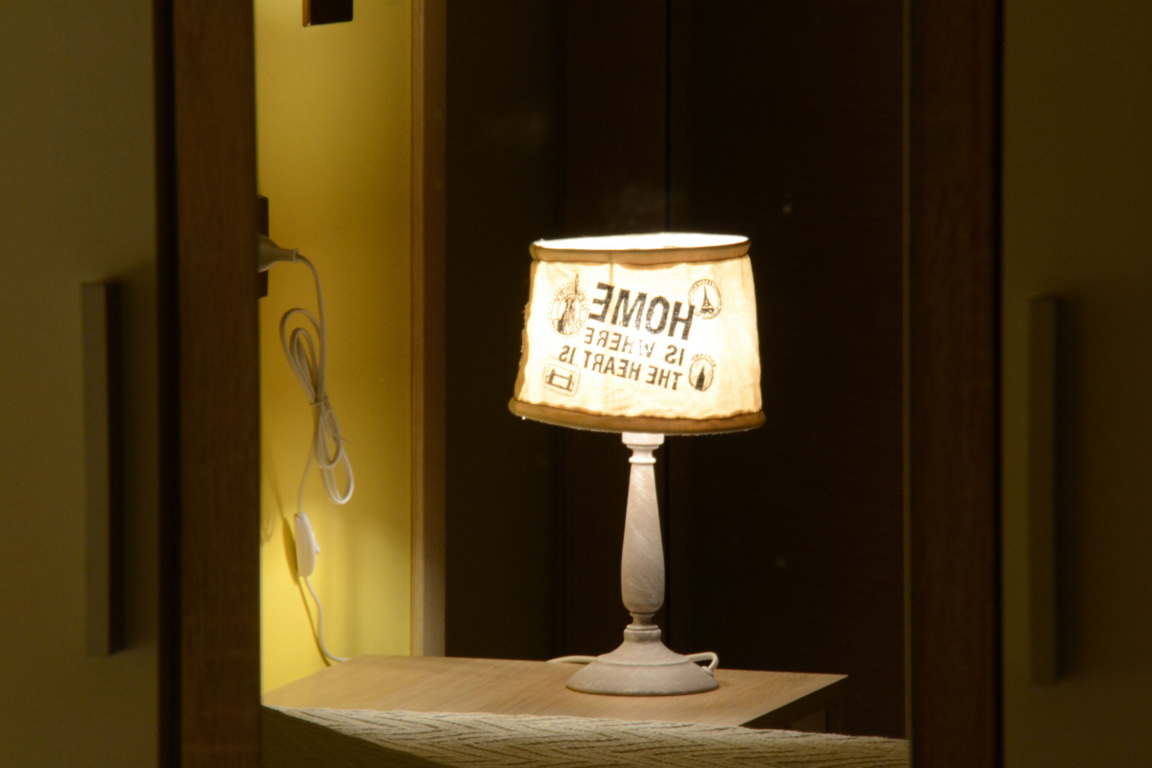 A lamp with a label reading "HOME 21 WHEELER 12 THE HEART IS 12".