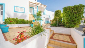 A white building with blue accents, a staircase, and potted plants. - Villa Loria - beautiful panoramic views (Albufeira)