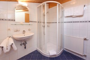 Shower, hair dryer, towels, toilet paper