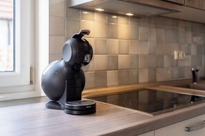 Fridge, stovetop, dishwasher, coffee/tea maker