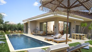 Une maison moderne dotée d’une piscine, de mobilier d’extérieur et d’une pergola.